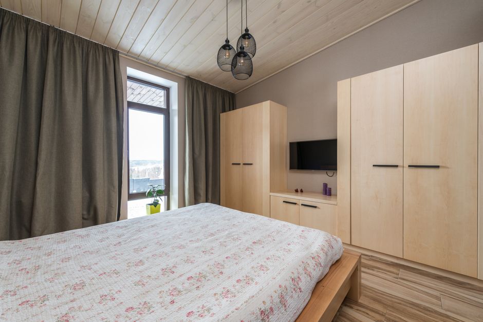 Inviting bedroom showcasing modern interior design with warm wooden elements and natural light. - Photo by Max Vakhtbovych on Pexels